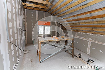 Interior of room apartment with new window and materials home-made scaffold, drills, level during on the renovation Stock Photo