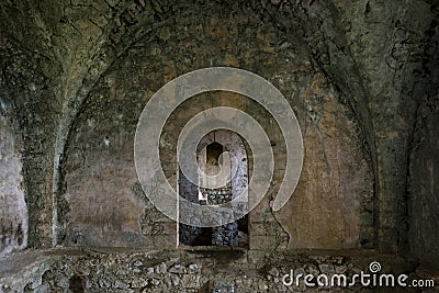 Interior of ruined hall with cracked, damaged walls and corridor in the St Hilarion ancient castle, Kyrenia Stock Photo