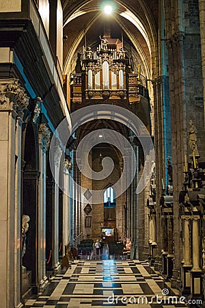 Interior of the Saint Bavo Cathedral or Sint-Baafs Cathedral in Ghent, Belgium, Europe, with columns and an organ at the top Editorial Stock Photo