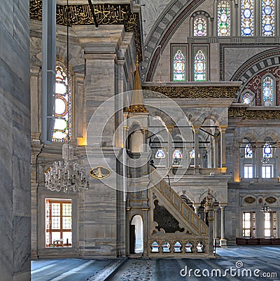 Interior shot of Nuruosmaniye Mosque with minbar platform, arches & colored stained glass windows, Istanbul, Turkey Stock Photo