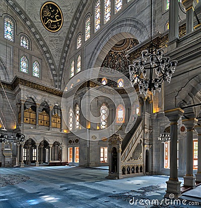 Interior shot of Nuruosmaniye Mosque with minbar platform, huge arches & colored stained glass windows, Istanbul, Turkey Stock Photo