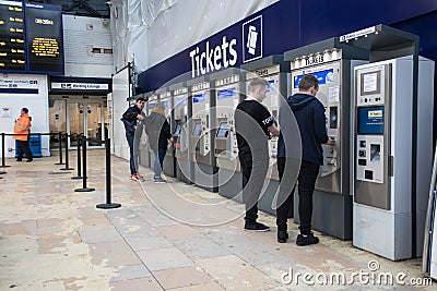 Interior shot of Queen Street Glasgow Railway Station during renovations. Shows customers at ticket machines Editorial Stock Photo