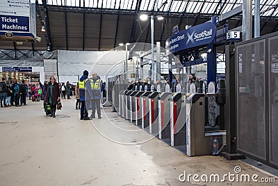 Interior shot of Queen Street Glasgow Railway Station during renovations. Shows ticket barriers, signage and people Editorial Stock Photo