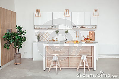 Interior of small white kitchen with fresh fruit, two glasses of orange juice, baguette, red caviar, croissant and Stock Photo