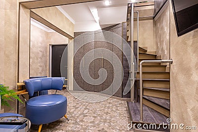 The interior is a spacious hallway, with a staircase to the second floor Stock Photo