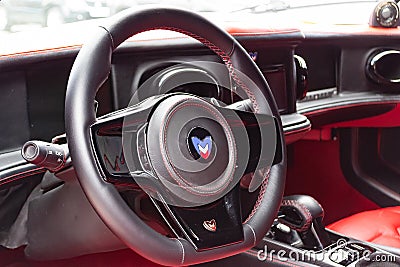 Interior of a sports car Marussia B1 of red color with elegant leather seats, low seating position and steering wheel of a Editorial Stock Photo