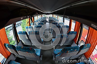 Interior of the tourist bus for excursions and long trips. A lot of free seats and places for small luggage Stock Photo