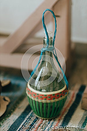 Interior of traditional house-museum from inside. Antique glass bottle for wine, kitchen utensil in Ethno museum Editorial Stock Photo