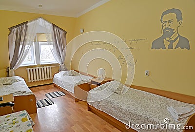 Interior of the triple hotel room with a portrait of the Russian writer A.P. Chekhov on a wall Stock Photo