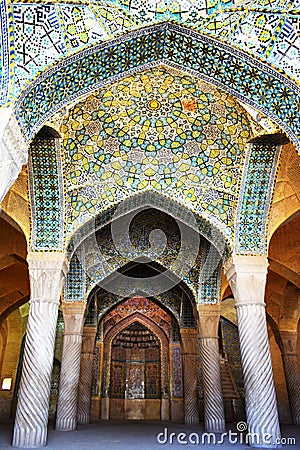 The interior of Vakil Mosque with large columns and crescent-shaped ceilings, with beautiful Iranian decorations and tiles,Shiraz. Stock Photo