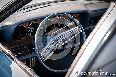 Interior view of classic long station wagon with wood-veneered doors, it's a blue Ford Gran Torino. Editorial Stock Photo