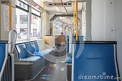 Interior view of a corridor inside passenger trains with blue fabric seats of German railway train system. Stock Photo