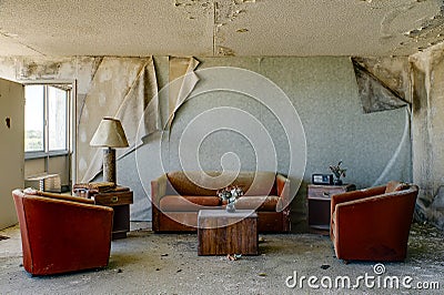 Intact Lodging Room with Burnt Orange Chairs & Couch - Abandoned Hotel Stock Photo