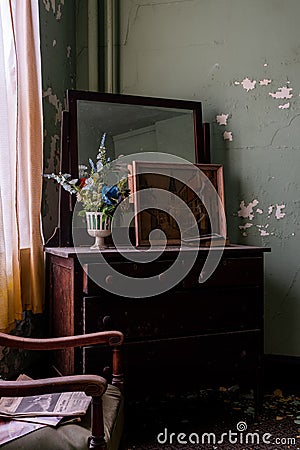 Derelict Intact Guest Room with Dresser + Flowers - Abandoned Wyoming Hotel - Mullens, West Virginia Stock Photo