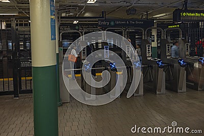 Interior view of New York subway station. Subway gate ticket machines on front. New York. Editorial Stock Photo