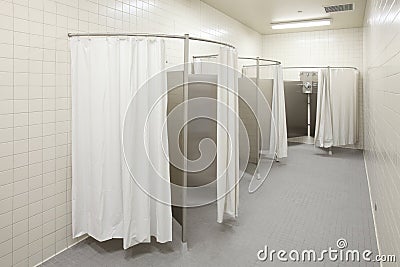 Private showers in a high school locker room. Stock Photo