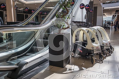 Interior view of shopping centre showing childs police buggie Editorial Stock Photo