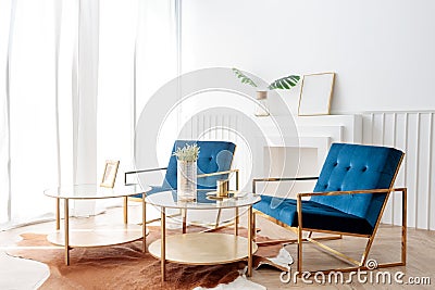 Interior view of two elegance comfortable armchair and gold glass coffee table in living room Stock Photo