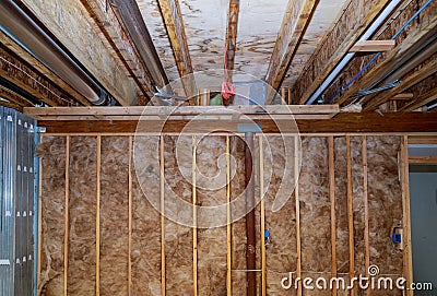 Interior wall insulation of basement with fiberglass cold barrier and insulation material Stock Photo