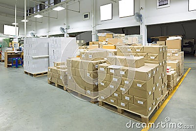 Interior of a warehouse with pallet stacker, boxes. Stock Photo