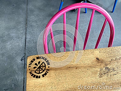 The interior wooden table with burned in logo of a Lime Fresh Mexican Grill in Orlando, FL Editorial Stock Photo