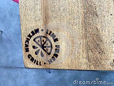 The interior wooden table with burned in logo of a Lime Fresh Mexican Grill in Orlando, FL Editorial Stock Photo