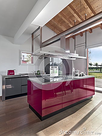 Interiors of a modern red lacquered kitchen in the foreground the island kitchen Stock Photo