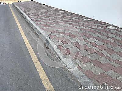 Interlock Tile flooring and protected by Kerb precast Concrete stones before the highways or roadways infrastructure Stock Photo