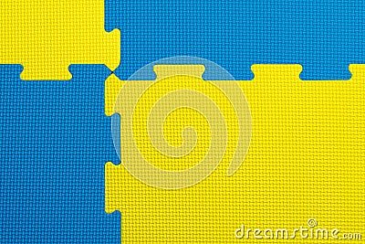 Interlocking blue and yellow EVA foam flooring tiles inside a gym, nursery, play room or school Stock Photo