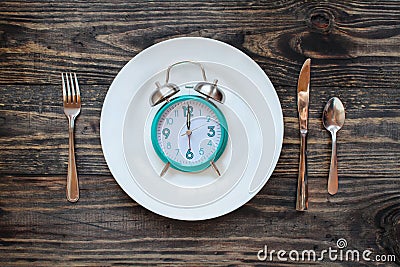 Intermittent Fasting Concept with Clock on Plate Stock Photo