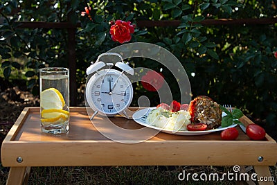 Intermittent fasting diet and Concept for healthy eating and nutrition. Alarm clock and diet food ingredients on wooden Stock Photo