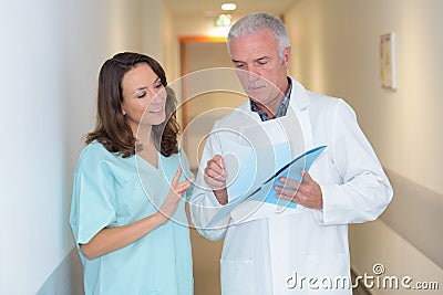 Intern and doctor on hallway Stock Photo