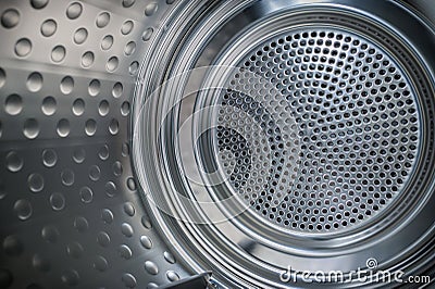 Internal closeup view of dryer stainless steel drum. Stock Photo
