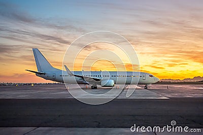 International Airlines Plane Parking Outside The Terminal In The Airport. White Passenger Airplane Side View, Sunset Stock Photo