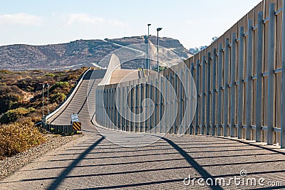 International Border Wall Between San Diego and Tijuana Extending into Distant Hills Stock Photo