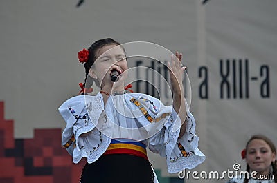 International Folklore Festival: Romanian girl singer in traditional costume Editorial Stock Photo