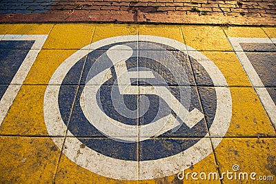 International handicapped symbol painted on walking path in the park background Stock Photo