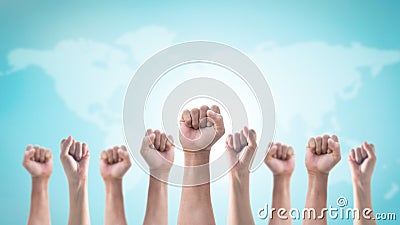 International human rights or labor day with Hands with clenched fist of people crowd men and women on world map Stock Photo