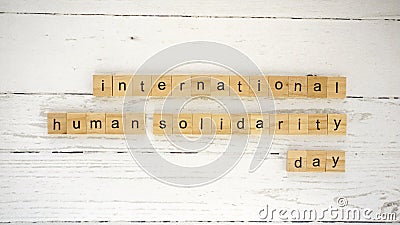 international human solidarity day.words from wooden cubes with letters photo Stock Photo