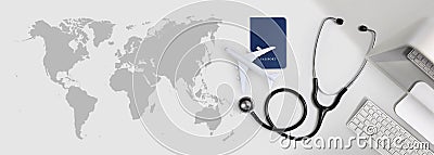 International medical travel insurance concept, stethoscope, passport, computer and airplane in desk office banner with global map Stock Photo