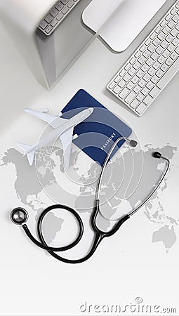 International medical travel insurance concept, stethoscope, passport, computer and airplane in desk office with global map Stock Photo