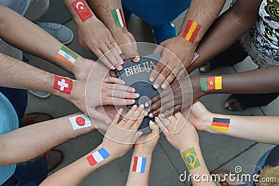International people with flags holding a bible Stock Photo