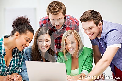 International students looking at laptop at school Stock Photo