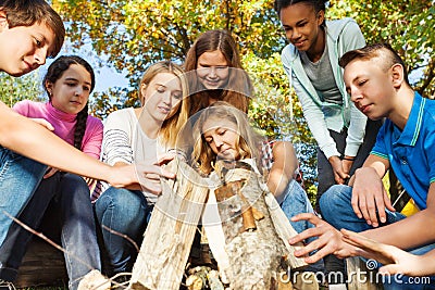 International teens construct bonfire together Stock Photo