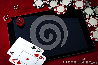 Internet casino and online gambling concept with two cards aces on a digital tablet, dice used to play the game of craps, black Stock Photo