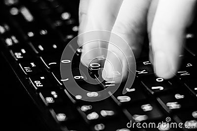 Internet crime concept. Hacker working on a code on dark digital background with digital interface around. Stock Photo