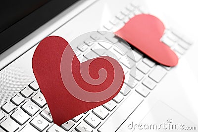 Internet dating concept - two paper hearts on computer keyboard Stock Photo