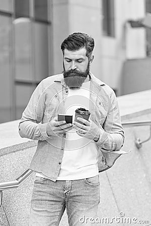 Internet surfing social networks with smartphone. Energy. Coffee time. Mobile phone always with me. Man use smartphone Stock Photo