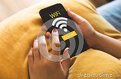 Internet wifi concepts with close up young female using smartphone on sofa. technology communication Editorial Stock Photo