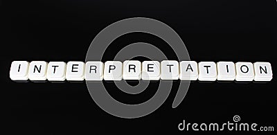 Interpretation text word title caption label cover backdrop background. Alphabet letter toy blocks on black reflective background. Stock Photo